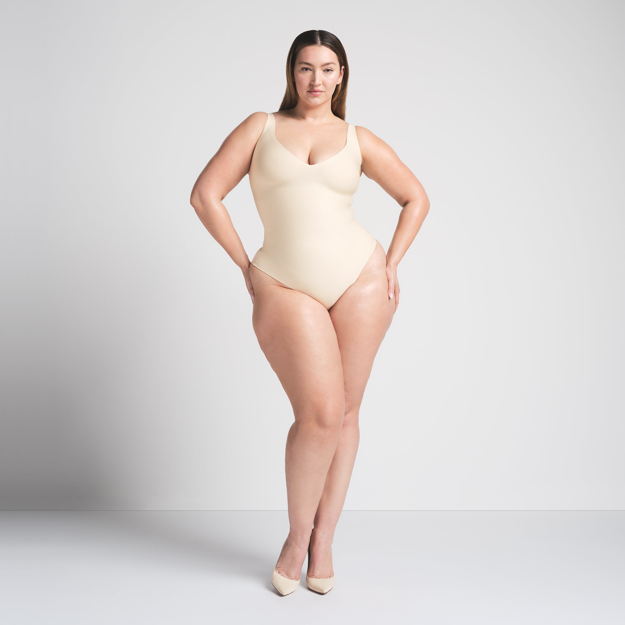 SKIMS BODY UNLINED PLUNGE THONG BODYSUIT | SAND